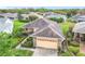 Aerial view of a single-story home showcasing a landscaped yard and brick paved driveway at 253 Lake Cassidy Dr, Kissimmee, FL 34759