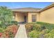 Charming front entry with colorful flowers, neatly trimmed bushes, and stone-paved walkway at 253 Lake Cassidy Dr, Kissimmee, FL 34759