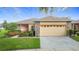 Charming single-story home with stone accents, manicured lawn, and well-kept landscaping at 253 Lake Cassidy Dr, Kissimmee, FL 34759