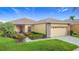 Attractive home featuring lush landscaping, a well-maintained lawn, and stone accents at 253 Lake Cassidy Dr, Kissimmee, FL 34759