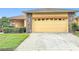 Lovely exterior showcasing a brick paver driveway and stone details around the garage at 253 Lake Cassidy Dr, Kissimmee, FL 34759