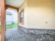 Covered front porch with a neutral color scheme, stone accents, brick pavers, and a view of the neighborhood at 253 Lake Cassidy Dr, Kissimmee, FL 34759