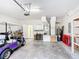 Spacious garage features a golf cart, water heater, HVAC system and storage shelving at 253 Lake Cassidy Dr, Kissimmee, FL 34759
