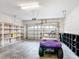Well-lit garage featuring a golf cart, storage shelves, and an automatic door opener at 253 Lake Cassidy Dr, Kissimmee, FL 34759