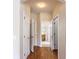 Hallway with hard wood flooring and white doors accessing bedrooms and bathrooms at 253 Lake Cassidy Dr, Kissimmee, FL 34759
