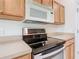 Close-up of kitchen featuring stainless steel oven/stovetop and built in microwave at 253 Lake Cassidy Dr, Kissimmee, FL 34759