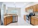 Eat-in kitchen featuring tile flooring, stainless steel appliances, and light wood cabinetry at 253 Lake Cassidy Dr, Kissimmee, FL 34759