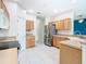 Well-lit kitchen with stainless steel appliances, light cabinets, and a white tile floor at 253 Lake Cassidy Dr, Kissimmee, FL 34759