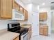 Kitchen featuring stainless steel appliances, light cabinets, and tiled floor at 253 Lake Cassidy Dr, Kissimmee, FL 34759