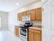 Kitchen featuring tile flooring, stainless steel appliances, and light wood cabinetry at 253 Lake Cassidy Dr, Kissimmee, FL 34759