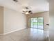 Living room featuring neutral paint, tile floors, and ceiling fan at 253 Lake Cassidy Dr, Kissimmee, FL 34759