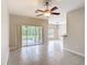 Open-concept living area with tile flooring and view of screened-in lanai at 253 Lake Cassidy Dr, Kissimmee, FL 34759
