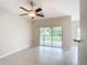 Bright living room with tile floors and sliding glass doors to screened lanai at 253 Lake Cassidy Dr, Kissimmee, FL 34759