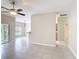 Living room with view to kitchen and hallway at 253 Lake Cassidy Dr, Kissimmee, FL 34759