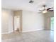 Spacious living area with tile flooring, a ceiling fan, and sliding glass doors to the outside at 253 Lake Cassidy Dr, Kissimmee, FL 34759