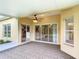 Covered patio with tiled flooring, ceiling fan, and sliding glass doors leading to the kitchen at 253 Lake Cassidy Dr, Kissimmee, FL 34759