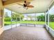 Spacious screened patio with tile flooring and ceiling fan, perfect for outdoor relaxation and enjoying the backyard view at 253 Lake Cassidy Dr, Kissimmee, FL 34759