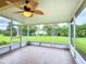 Relaxing screened-in porch that provides a serene view of the green backyard at 253 Lake Cassidy Dr, Kissimmee, FL 34759