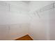 Empty walk-in closet with a shelf system ready for storage and organization at 253 Lake Cassidy Dr, Kissimmee, FL 34759