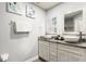 Bright bathroom featuring a double vanity, granite counters, and decorative coastal artwork at 2537 Renshaw St, Kissimmee, FL 34747