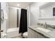 Bathroom featuring modern granite vanity, and shower with tiled accent wall at 2537 Renshaw St, Kissimmee, FL 34747