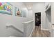 Upstairs hallway with wall art and view into a bonus room at 2537 Renshaw St, Kissimmee, FL 34747