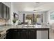 A view of the kitchen island, showcasing granite countertops, stainless steel appliances, and open layout at 2537 Renshaw St, Kissimmee, FL 34747