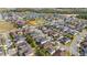 Aerial view of a residential neighborhood with meticulously maintained lawns and a scenic pond in the background at 3242 Irish Peach Dr, Winter Garden, FL 34787