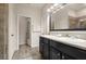 Bright bathroom featuring a double sink vanity, a large mirror and a walk-in shower at 3242 Irish Peach Dr, Winter Garden, FL 34787