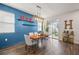 Dining area with wood floors, blue accent wall and modern lighting fixture at 3242 Irish Peach Dr, Winter Garden, FL 34787