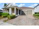 Charming home featuring a well-manicured lawn, covered entryway, and a two-car garage at 3242 Irish Peach Dr, Winter Garden, FL 34787