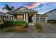 Charming home featuring a well-manicured lawn, covered entryway, and a two-car garage at 3242 Irish Peach Dr, Winter Garden, FL 34787