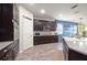 Kitchen showcasing dark cabinets, stainless steel appliances and a view of the dining area at 3242 Irish Peach Dr, Winter Garden, FL 34787
