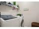 Neat laundry room with modern washer and dryer, plus storage solutions at 3242 Irish Peach Dr, Winter Garden, FL 34787