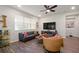 Bright living room showcasing a comfortable leather sofa, modern furnishings, and a large window for natural light at 3242 Irish Peach Dr, Winter Garden, FL 34787