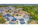 Drone's eye view of a home situated in a friendly neighborhood, enhanced by mature trees and a community atmosphere at 368 Sand Ridge Dr, Davenport, FL 33896