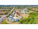 An aerial view of a residential area with a mix of housing and greenery, near a busy street at 368 Sand Ridge Dr, Davenport, FL 33896