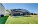 Backyard view of an enclosed pool and outdoor living area with well-maintained landscaping and a private setting at 368 Sand Ridge Dr, Davenport, FL 33896