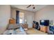 Neutral bedroom with a ceiling fan, a small window, and a neatly made bed at 368 Sand Ridge Dr, Davenport, FL 33896