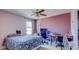 A cozy bedroom is furnished with desk, chair, and ceiling fan at 368 Sand Ridge Dr, Davenport, FL 33896