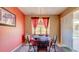 Dining area with table, red curtains, and sliding glass doors leading to outdoor pool at 368 Sand Ridge Dr, Davenport, FL 33896