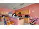 Kitchen featuring wood cabinets, black appliances, and bar seating at 368 Sand Ridge Dr, Davenport, FL 33896