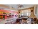 Open-concept living room with bar seating and a view into the dining area, featuring neutral tones and stylish accents at 368 Sand Ridge Dr, Davenport, FL 33896