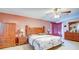 Spacious main bedroom with a ceiling fan, carpeted floors, and a large dresser at 368 Sand Ridge Dr, Davenport, FL 33896