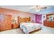 Large main bedroom with wood furniture and a ceiling fan at 368 Sand Ridge Dr, Davenport, FL 33896