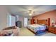 Main bedroom featuring a bed and ceiling fan with carpeted floors at 368 Sand Ridge Dr, Davenport, FL 33896