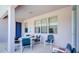 Cozy covered patio, perfect for outdoor dining and entertaining, with a charming blue door and ample seating at 368 Sand Ridge Dr, Davenport, FL 33896