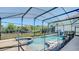 Backyard pool area with a fenced in pool and a view of trees at 368 Sand Ridge Dr, Davenport, FL 33896