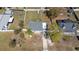 Aerial view of a well-maintained property with a gray roof, mature trees, and a long driveway at 3764 Pinehurst St, Deltona, FL 32738