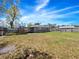 Fenced backyard featuring grass and leaves, with view of house at 3764 Pinehurst St, Deltona, FL 32738